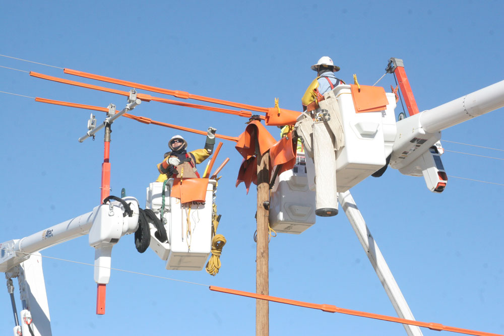 Navajo Tribal Utility Authority crews work to install electricity to remote areas in the western portion of the Navajo Nation. (Courtesy Navajo Tribal Utility Authority)