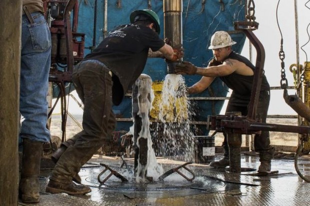 Workers connect drill bits and drill collars, used to extract natural petroleum, on Endeavor Energy Resources LP's Big Dog Drilling Rig 22 in the Permian basin outside of Midland, Texas, U.S., on Friday, Dec. 12, 2014. Of all the booming U.S. oil regions set soaring by a drilling renaissance in shale rock, the Permian and Bakken basins are among the most vulnerable to oil prices that settled at $57.81 a barrel Dec. 12. With enough crude by some counts to exceed the reserves of Saudi Arabia, theyre also the most critical to the future of the U.S. shale boom. (Bloomberg via Getty Images)