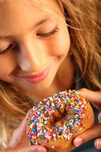 Young Girl Looking at Doughnut