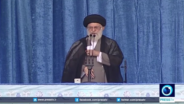 Toward the end of his remarks, Khamenei let go of the gun and balanced it on the podium. (Image source: YouTube/PressTV)