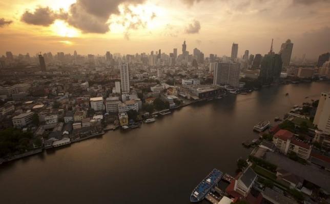 The skyline of central Bangkok and the Chao Phraya river are seen during sunrise in Bangkok April 22, 2015. REUTERS/Athit Perawongmetha