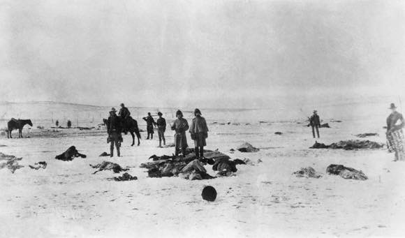 At The Battle Of Wounded Knee on Dec. 29th,1890, Black Elk on horseback charged soldiers and helped to rescue some of the wounded. He arrived after Spotted Elk's (Big Foot's) band of people had been shot and he was grazed by a bullet to his hip. Pictured here is the terrible aftermath of the massacre. AP Images. 