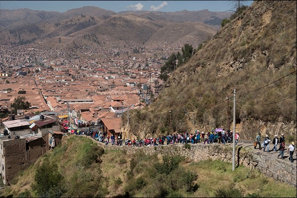 Families walk from the center of Cusco toward the temple site at Sacsayhuaman to celebrate Inti Raymi, the Inka Festival of the Sun. Cusco, Peru; June 2014. Photo by Doug McMains, NMAI.