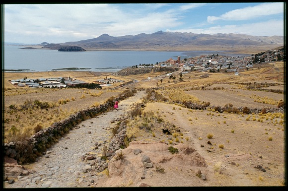 A woman travels the Inka Road on the shores of Lake Titicaca near Pomata, Peru. Photo by Megan Son and Laurent Granier, 2006.
