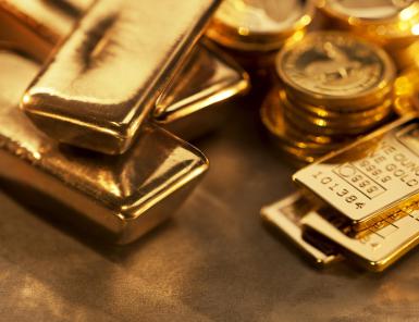 Gold ingots and coins close up - Anthony Bradshaw/ Digital Vision/ Getty Images