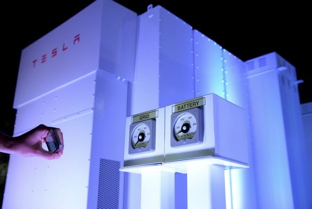A guests takes photographs of the Powerpack system after Elon Musk, CEO of Tesla unveiled suit of batteries for homes, businesses, and utilities at Tesla Design Studio April 30, 2015 in Hawthorne, California. Musk unveiled the home battery named Powerwall with a selling price of $3500 for 10kWh and $3000 for 7kWh and very large utility pack called Powerpack. (Kevork Djansezian/Getty Images)