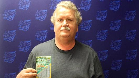 Danny Chasteen, with his winning $250,000 lottery ticket in July. Chasteen said lottery officials told they can't release the money because state lawmakers haven't passed a budget.