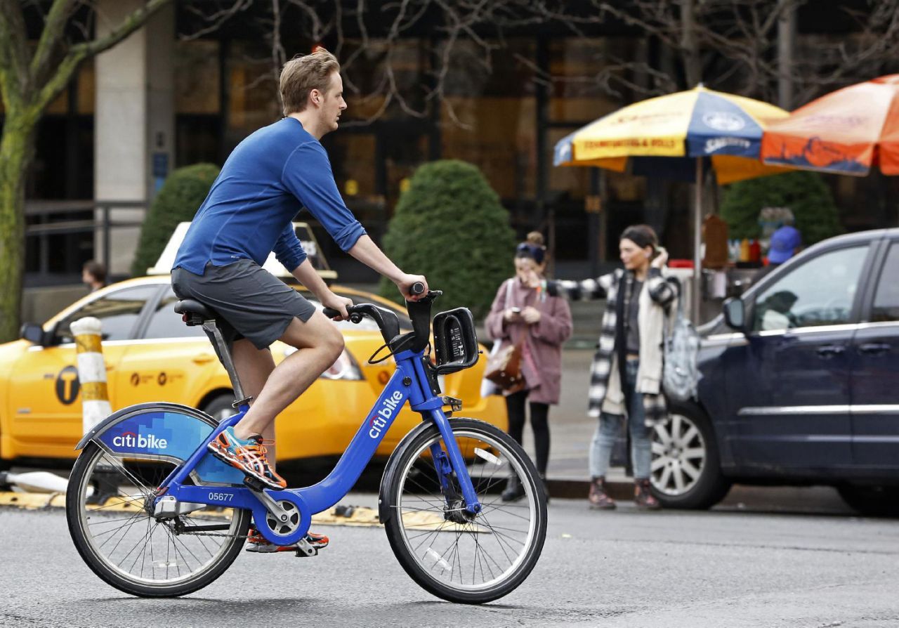 FILE - In this Dec. 24, 2015 file photo, a cyclist wearing shorts, sneakers and no socks, rides a rental bike through a downtown Manhattan street on Christmas Eve, in New York, as warm temperatures, rising into the 70&#39;s in New York.  Global warming has made the average daily weather for Americans more pleasant over the last 40 years, which may explain why much of the public doesnt rank climate change as big a threat as scientists and the rest of the world do, a new study suggests. (AP Photo/Kathy Willens, File)