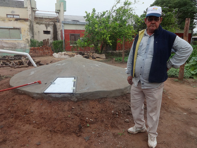 Local small farmer Jos Ramn Espinoza stands next to a recently constructed community tank for harvesting rainwater, which will enable a group of families to weather the recurrent drought in Corzuela, a rural municipality in the northeast Argentine province of Chaco. The underground tank was provided by GEFs Small Grants Programme. Credit: Fabiana Frayssinet/IPS