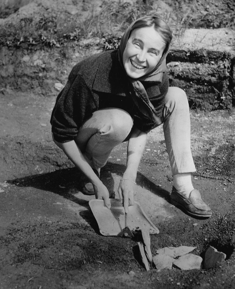 Co-discoverer Anne Ingstad examines a fire pit at the site in 1963. (Courtesy Wikipedia)