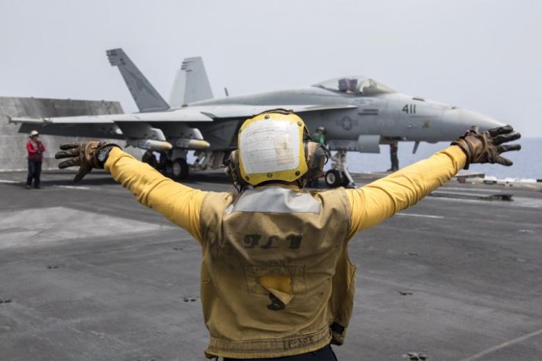 A U.S. Navy crewman directs an F/A-18E Super Hornet fighter jet on the flight deck of the aircraft carrier USS Harry S. Truman in the Mediterranean Sea in a photo released by the US Navy June 3, 2016. U  U.S. Navy/Mass Communication Specialist 3rd Class Anthony Flynn/Handout via REUTERS
