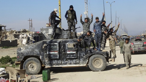 Iraqi security forces celebrate after regaining control of the town of Husaybah, 8 kilometres east of Ramadi, Iraq, ...