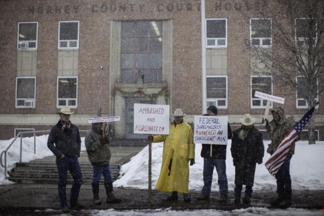Demonstrators stand near a court house during a protest against government actions in Burns, Oregon on January 29, 2016, a day after the FBI released video showing Robert "LaVoy" Finicum being shot by police.