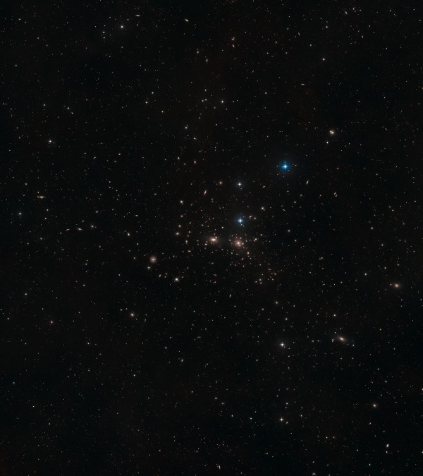 This image shows a ground-based wide-field view of the region around NGC 4889 from the Digitized Sky Survey 2. Image credit: NASA, ESA, Digitized Sky Survey 2