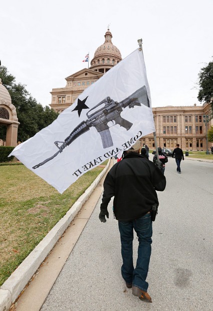 AUSTIN, TX - JANUARY 1: On January 1, 2016, the open carry law took effect in Texas, and 2nd Amendment activists held an open carry rally at the Texas state capitol on January 1, 2016 in Austin, Texas. Armando Valledares of Killeen holds the 'Come And Take It' flag. (Photo by Erich Schlegel/Getty Images)