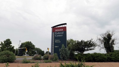 Storm clouds build over the sign that stands outside the main entrance to the Federal Center on Friday, July 1, 2016, in Lakewood, Colo. Investigators say a worker at a U.S. Geological Survey laboratory intentionally manipulated test results for years that may have affected 24 research projects on coal, water and other topics. (AP Photo/David Zalubowski)