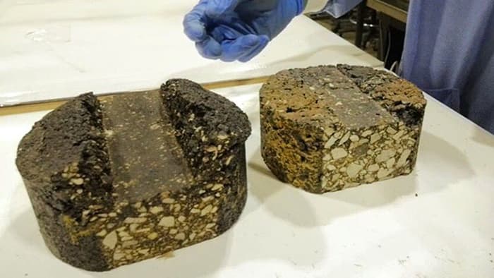 Chunks of asphalt made with binders derived from pig manure, which can replace the petroleum found ...