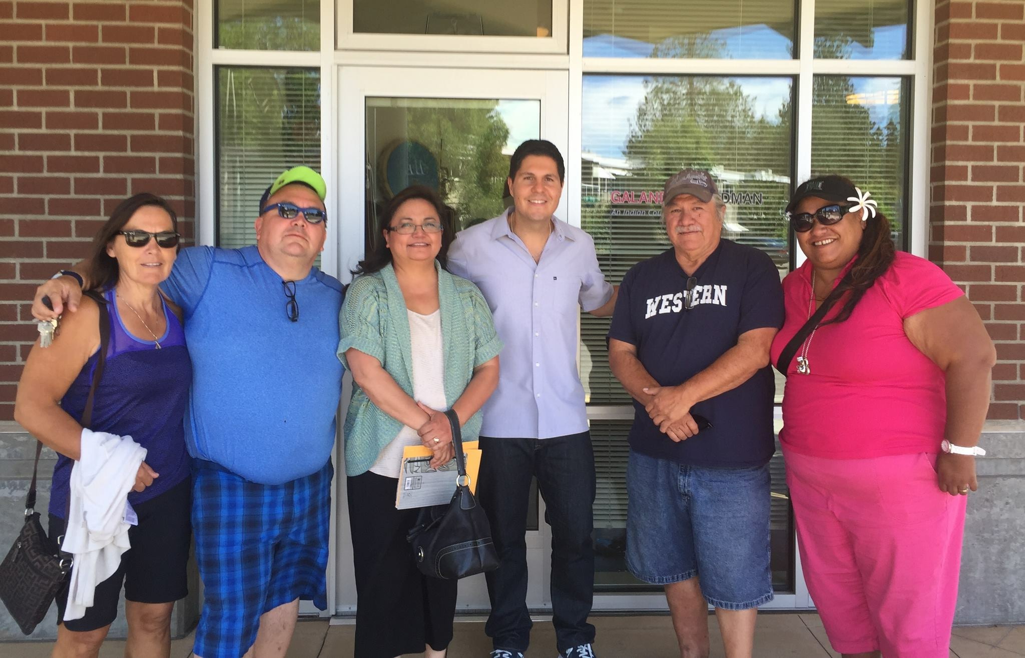 Nooksack tribal members facing disenrollment stand with their lawyer, Gabe Galanda, in front of Galanda�s Seattle office. Pictured, from left, are: Deborah Alexander, her brother Shxwha:y, Village Chief Robert Gladstone, Michelle Roberts, Gabe Galanda, Nooksack elder and language scholar George Adams, and Adeline Aure. (Courtesy Alice Hall)