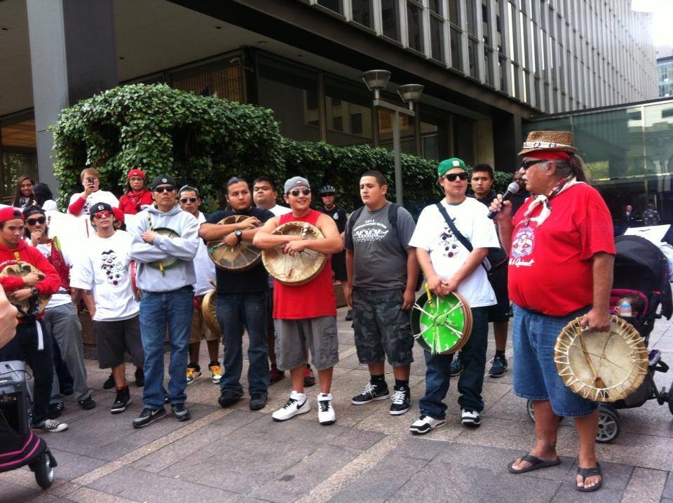 Nooksack tribal elder and last fluent speaker of the Nooksack language, George Adams, speaks at a 2013 rally in downtown Seattle against disenrollment. (Photo courtesy The Nooksack 306/Facebook)