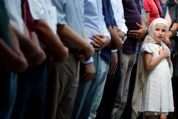 A young girl joins family members and friends during funeral prayers for Gulsen Bahadir, 28, a Turkish Airlines (THY) flight attendant killed Tuesday at the blasts at Ataturk airport, in Istanbul, Wednesday, June 29, 2016. Suicide attackers killed dozens and wounded more than 140 at Istanbul's busy Ataturk Airport late Tuesday, the latest in a series of bombings to strike Turkey in recent months. Turkish authorities have banned distribution of images relating to the Ataturk airport attack within Turkey. (AP Photo/Emrah Gurel)