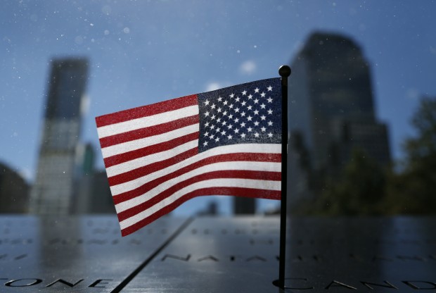 In this Sunday, Sept. 22, 2013 photo, a US flag is placed at the north reflecting pool of the 9/11 Memorial at the site of the 9/11 attacks on the World Trade Center in New York. (AP Photo/Lefteris Pitarakis) 
