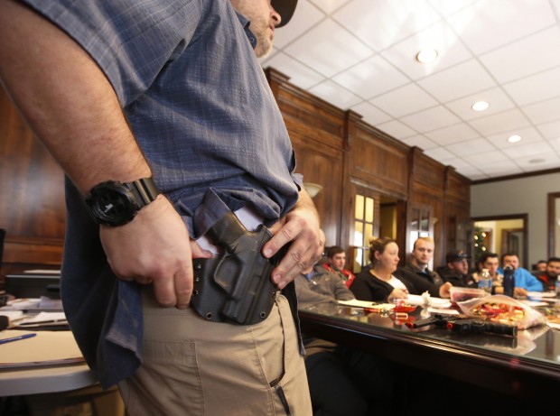 Damon Thueson shows a holster at a gun concealed carry permit class put on by 'USA Firearms Training' on December 19, 2015. (George Frey/Getty Images)