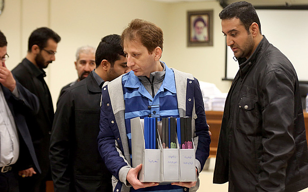Babak Zanjani carries his papers during his trial