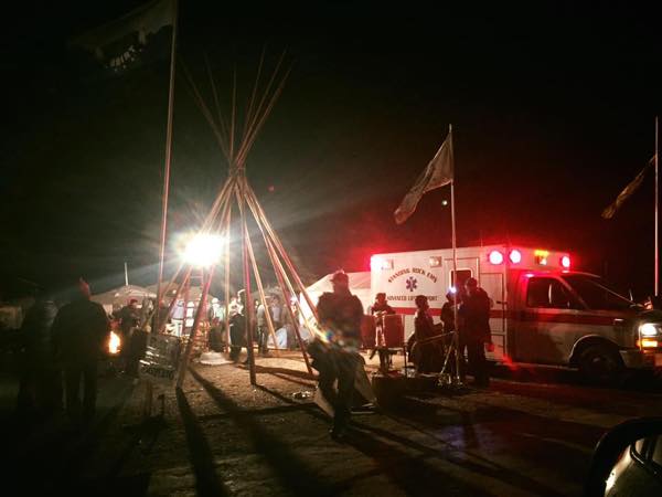 Ambulance is on hand for treatment of water protectors being hit with rubber bullets, tear gas, mace and water from cannons. (Photo: Twitter/Clayton Thomas Mueller)