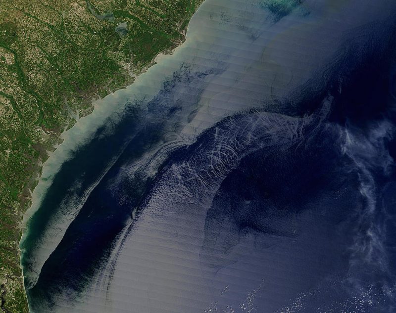 This image, obtained  by the Moderate Resolution Imaging Spectroradiometer (MODIS) on NASAs Terra satellite on April 18, 2004, shows the Georgia and Carolinas shoreline. The Gulf Stream is the water feature with a rough sea surface that appears to curve away from the coast.  Image via Jacques Descloitres, MODIS Rapid Response Team, NASA/GSFC http://visibleearth.nasa.gov/view.php?id=71157