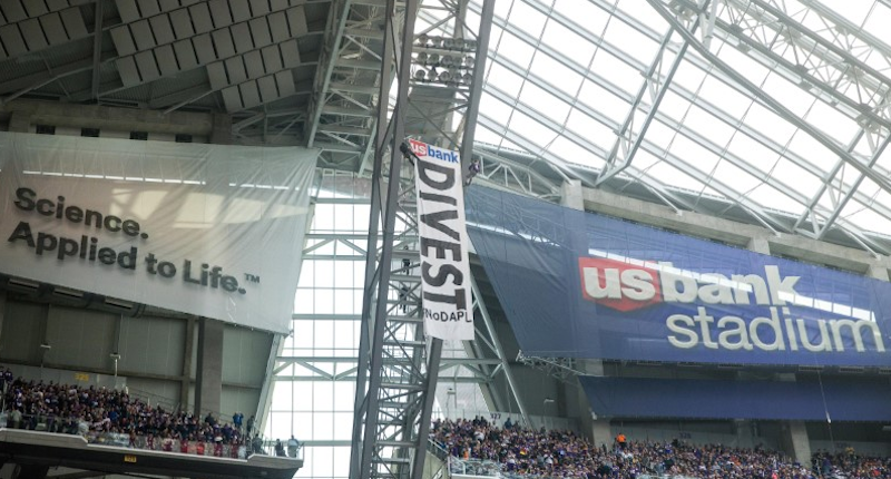 Two protestors rappel from the rafters with a banner against the Dakota Pipeline during the second quarter during a game between the Minnesota Vikings and Chicago Bears at U.S. Bank Stadium. (Mandatory Credit: Brace Hemmelgarn-USA TODAY Sports)