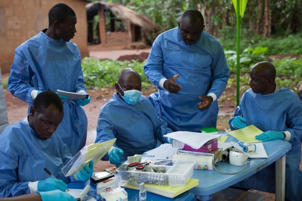 Workers carrying out the WHO Ebola vaccine trial in Katongourou, Guinea