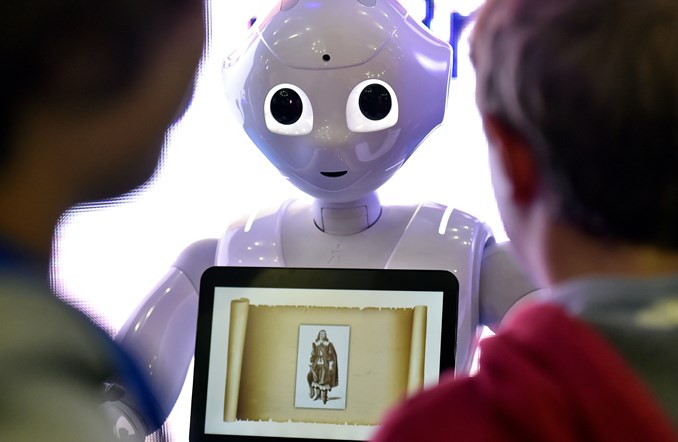 Image::Children interact with the programmable humanoid robot "Pepper," developed by French robotics company Aldebaran Robotics, at the Global Robot Expo in Madrid in 2016.|||[object Object]