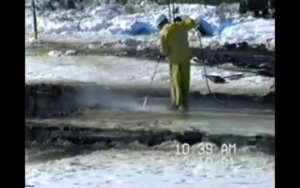 A clean-up worker and his hose against millions of gallons of oil that spilled after a pipeline ruptured near Grand Rapids, Minnesota, on March 3, 1991.