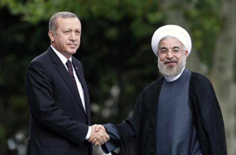 Iran's President Hassan Rouhani (R) is welcomed by Turkey's Prime Minister Tayyip Erdogan as he arrives for a meeting at Erdogan's office in Ankara June 9, 2014. REUTERS/Umit Bektas